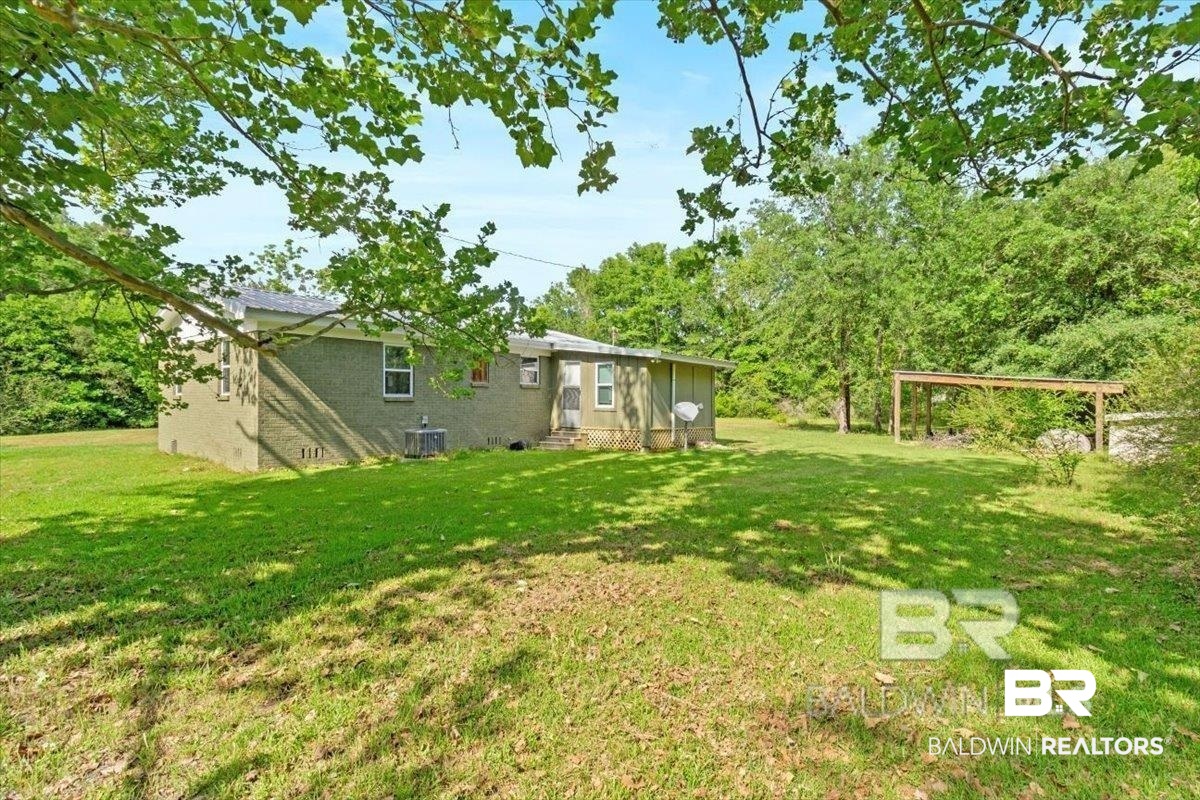 29397 Loper Road Loxley, AL 36551 - Photo 7 of 22 View of green lawn with entry steps