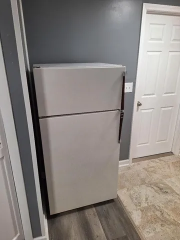 a white refrigerator freezer sitting in a kitchen