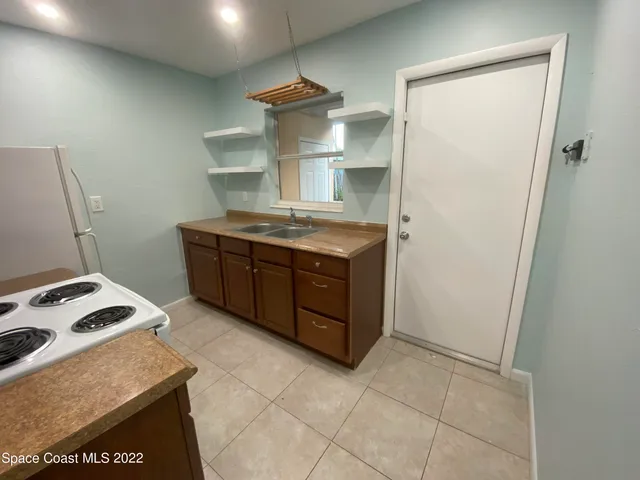 a kitchen with a stove and a refrigerator