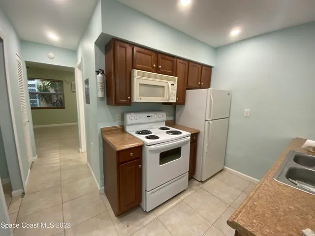 a kitchen with a stove and a refrigerator