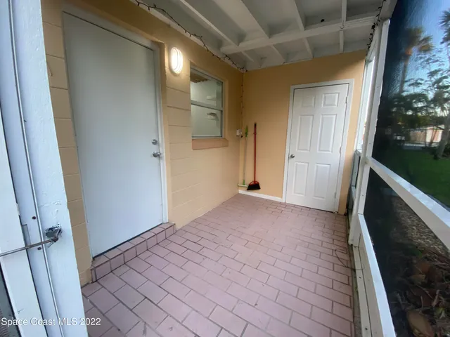 a view of hallway with stairs and a wooden floor
