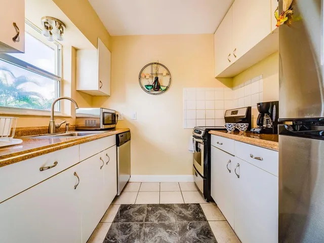 a kitchen with a refrigerator and a sink