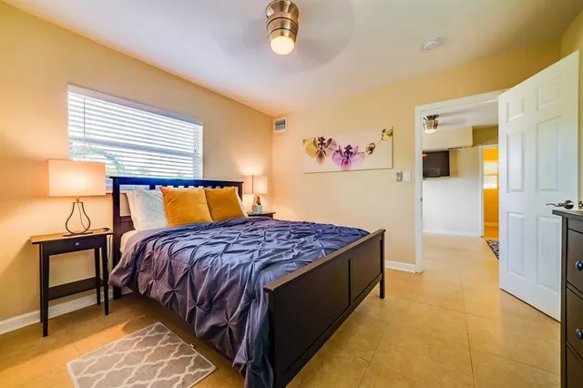 a bedroom with a bed and a lamp