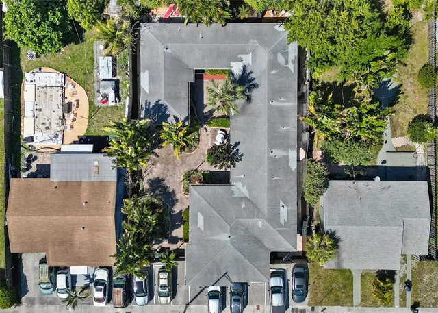 an aerial view of a house with a yard and a fountain