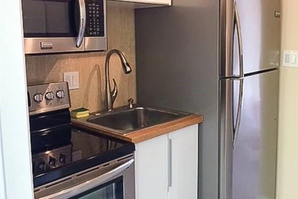 a kitchen with a sink stove and cabinets