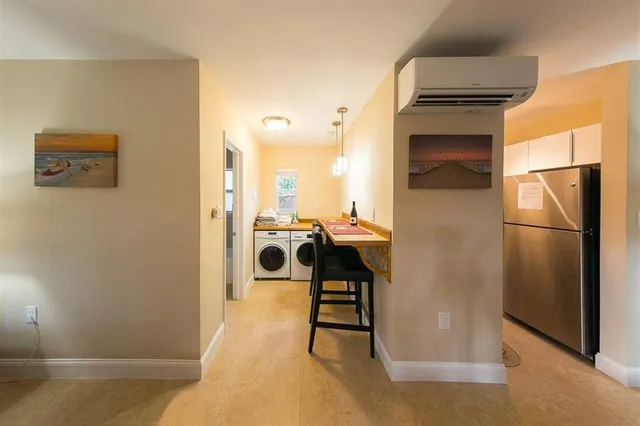 a view of a kitchen with a sink and refrigerator