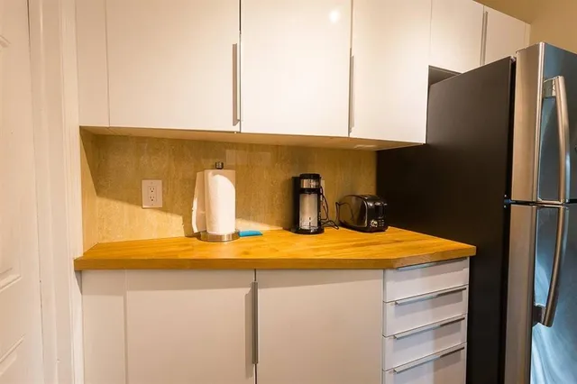 a kitchen with stainless steel appliances a refrigerator and stove