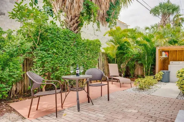 a view of a patio with table and chairs and potted plants
