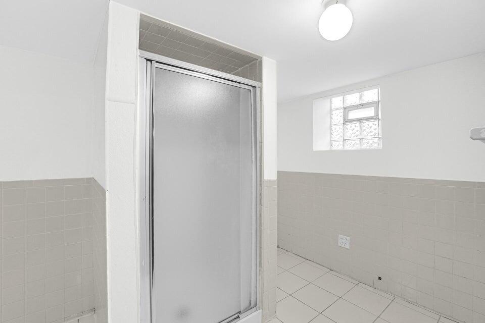 650 119th Street, Unit 1 Whiting, IN 46394 - Photo 14 of 17 a bathroom with a glass shower door