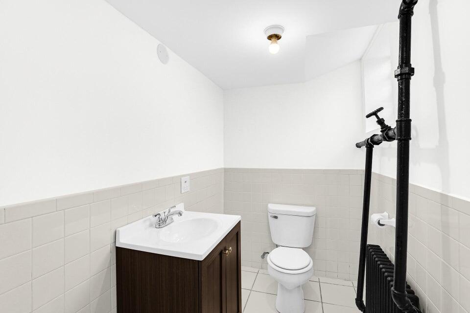 650 119th Street, Unit 1 Whiting, IN 46394 - Photo 15 of 17 a bathroom with a sink toilet and a mirror