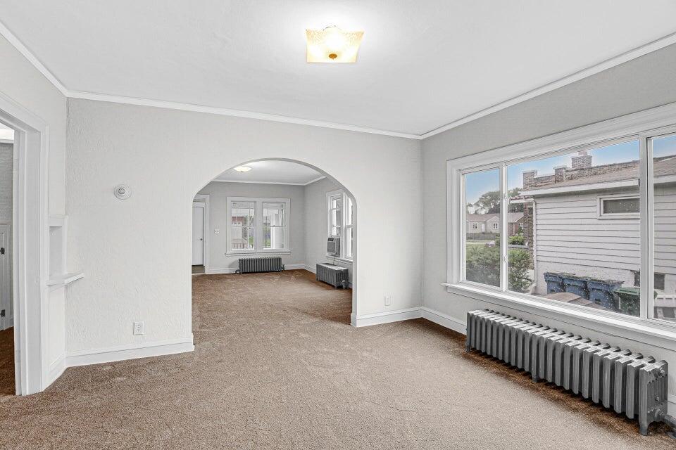 650 119th Street, Unit 1 Whiting, IN 46394 - Photo 6 of 17 a view of a room with large windows and a ceiling fan