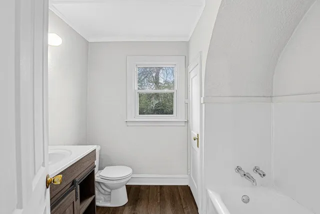 a view of a kitchen with sink and dishwasher with wooden floor