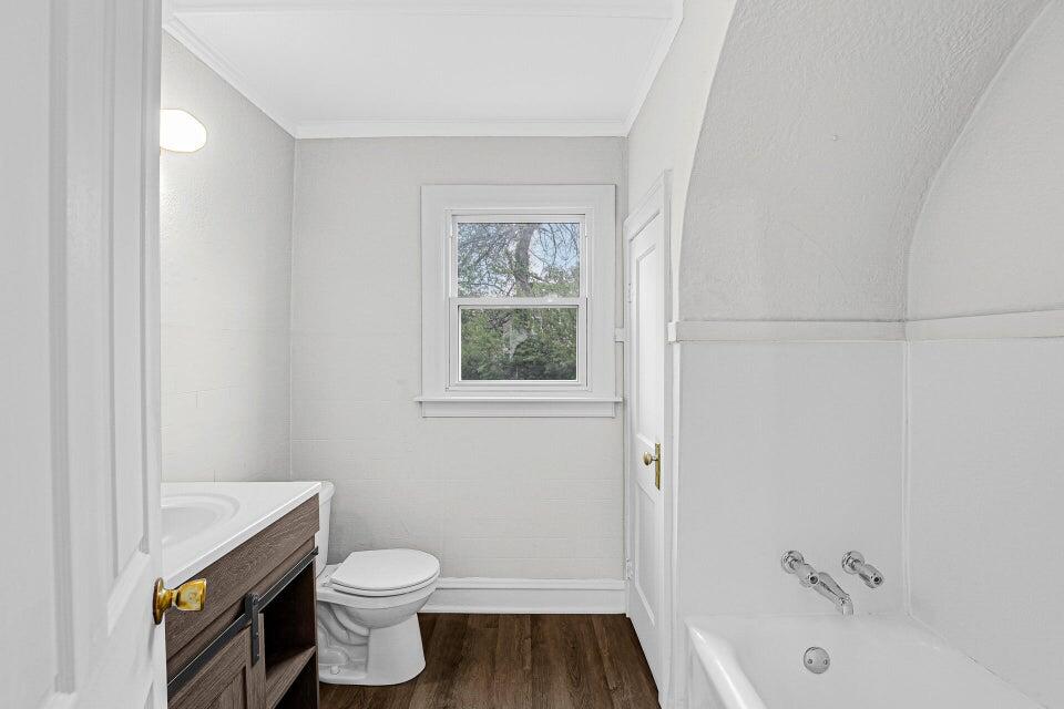650 119th Street, Unit 1 Whiting, IN 46394 - Photo 8 of 17 a bathroom with a granite countertop toilet a sink and bathtub