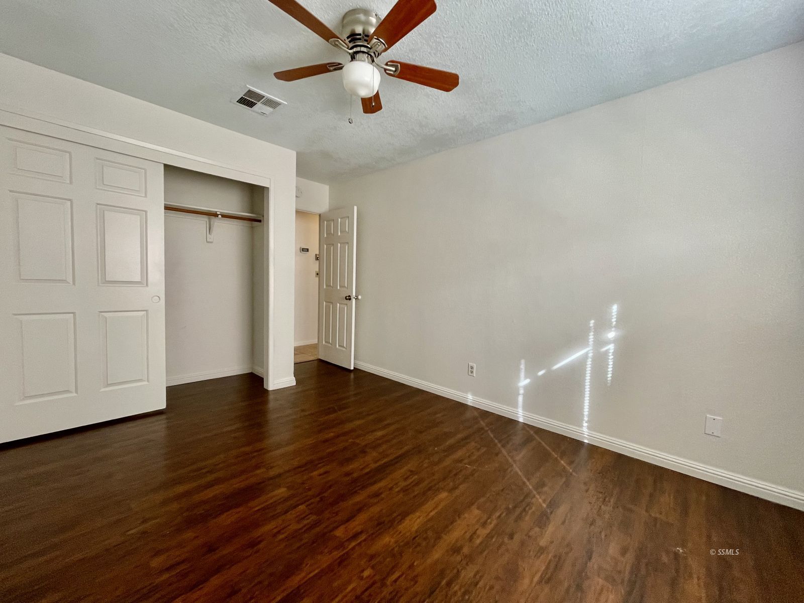 225 Michele Street Ridgecrest, CA 93555 - Photo 19 of 36 an empty room with wooden floor closet and windows