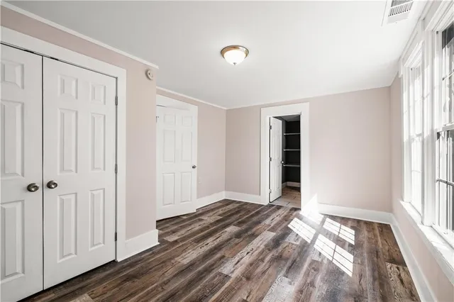 a view of an empty room with wooden floor
