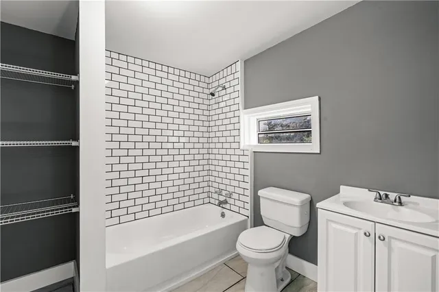 a bathroom with a toilet and a bathtub