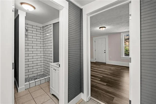a view of a hallway with wooden floor and staircase