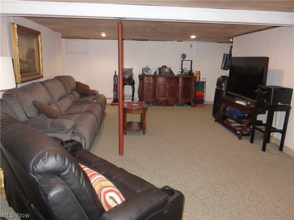 37416 Detroit Road Avon, OH 44011 - Photo 22 of 31 Carpeted family room featuring beamed ceiling
