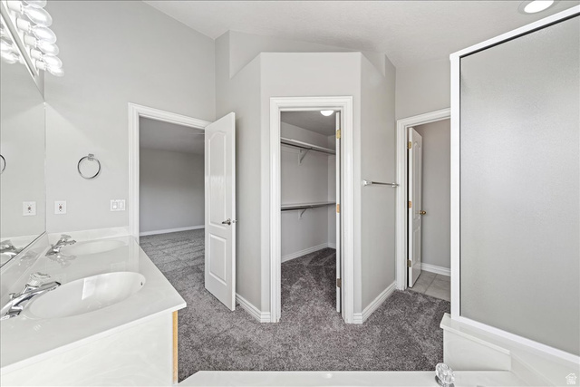 7 Reflection Way St. George, UT 84770 - Photo 47 of 54 Full bath featuring light carpet, a walk in closet, and double vanity