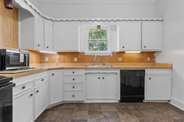 a kitchen with a refrigerator and a stove top oven