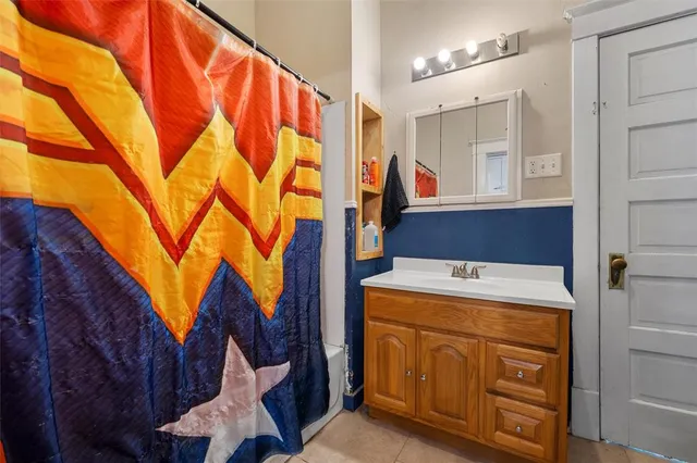 a living room with furniture a ceiling fan and a window