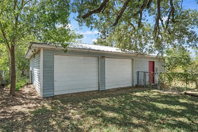 a view of a house with wooden deck and a yard