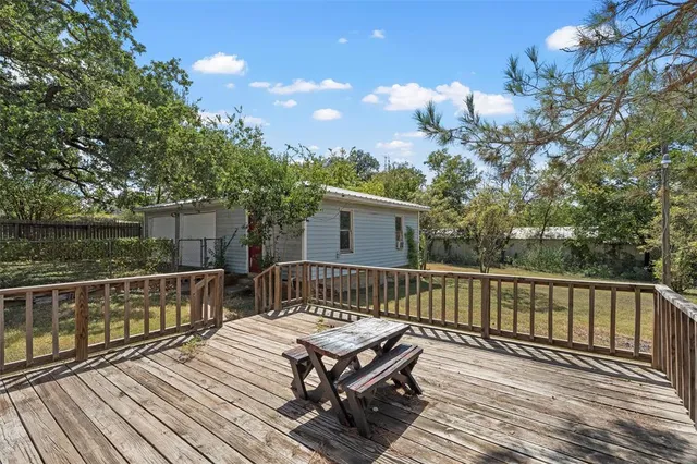 a view of a roof deck with wooden fence and floor