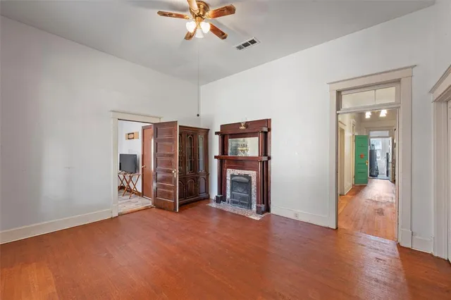 a view of a livingroom with furniture and a chandelier fan