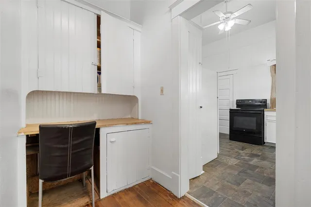 a kitchen with granite countertop white cabinets and white appliances
