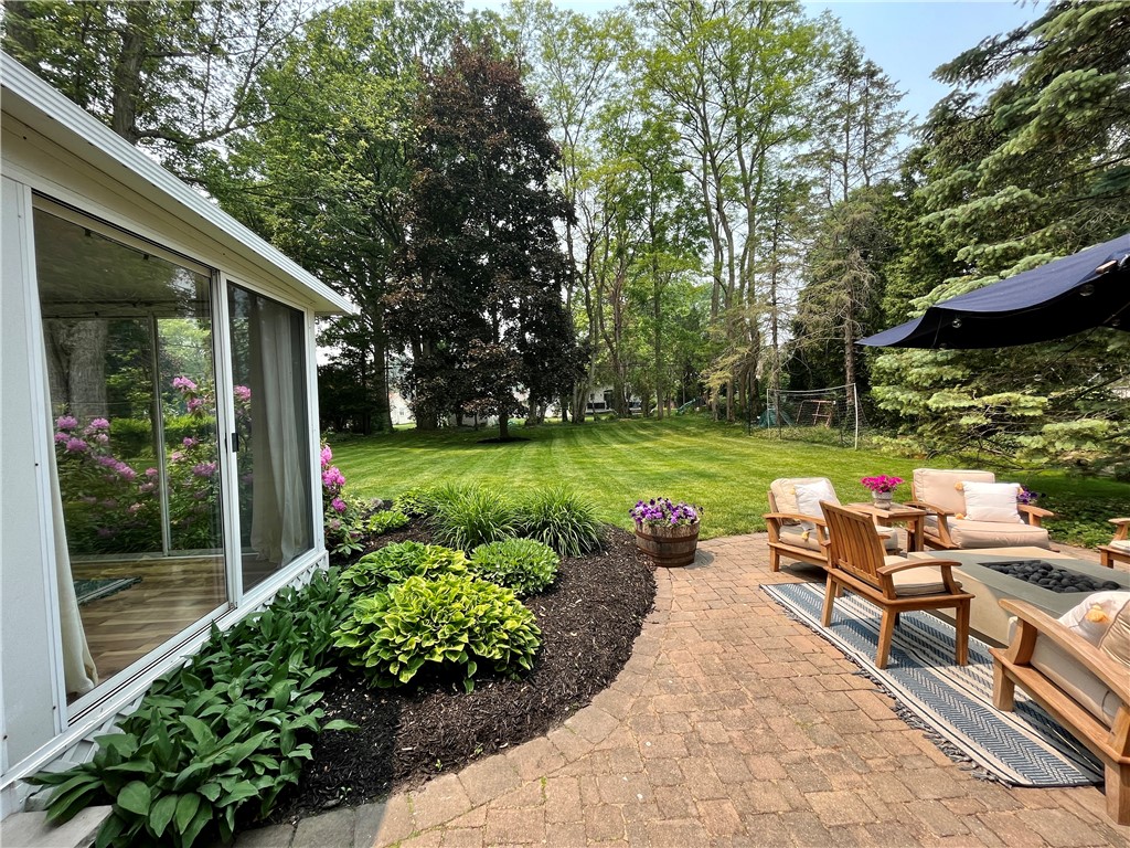 65 Jackson Rd Extension Penfield, NY 14526 - Photo 13 of 48 Backyard covered porch and patio