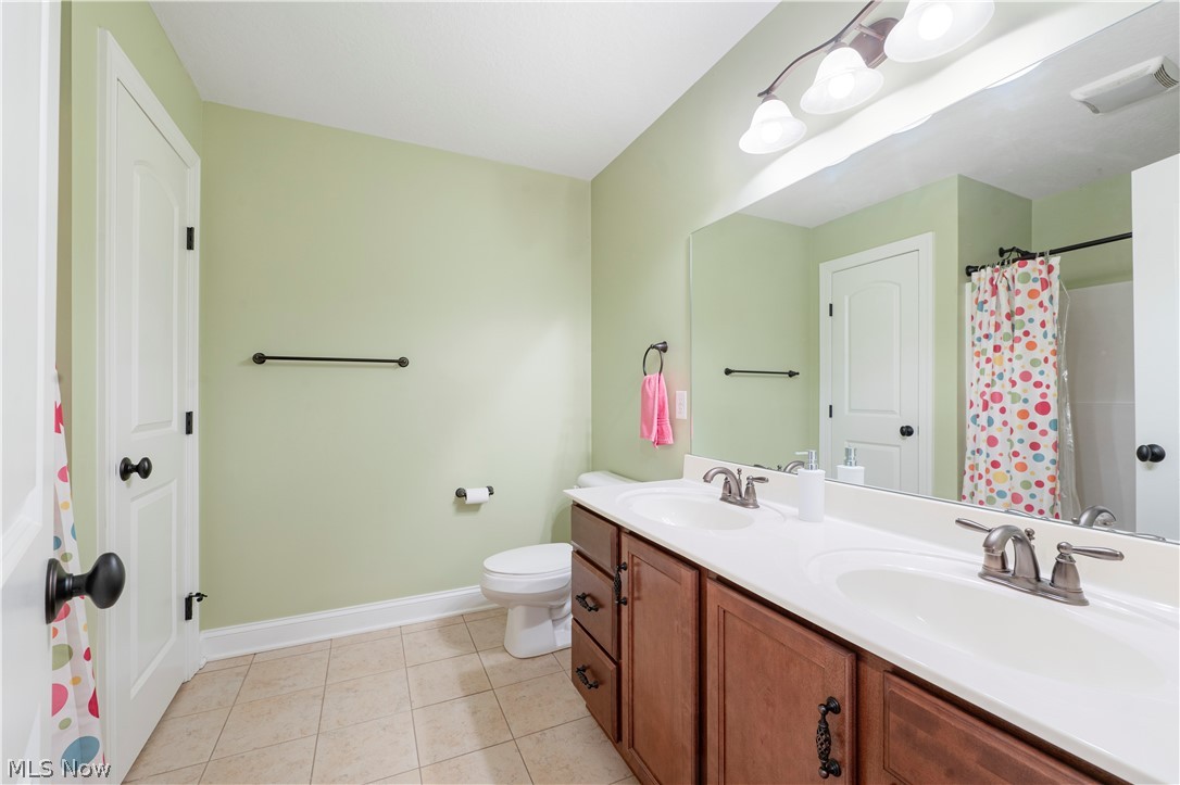 3356 Huntcliffe Road Northeast Canton, OH 44721 - Photo 45 of 50 Bathroom with tile patterned floors, toilet, and dual bowl vanity