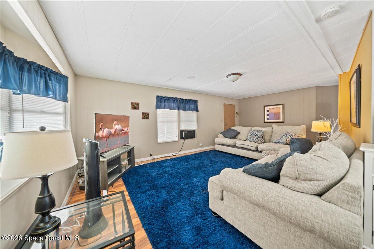 1740 Seagrape Street Northeast Palm Bay, FL 32905 - Photo 5 of 33 a living room with furniture and a wooden floor