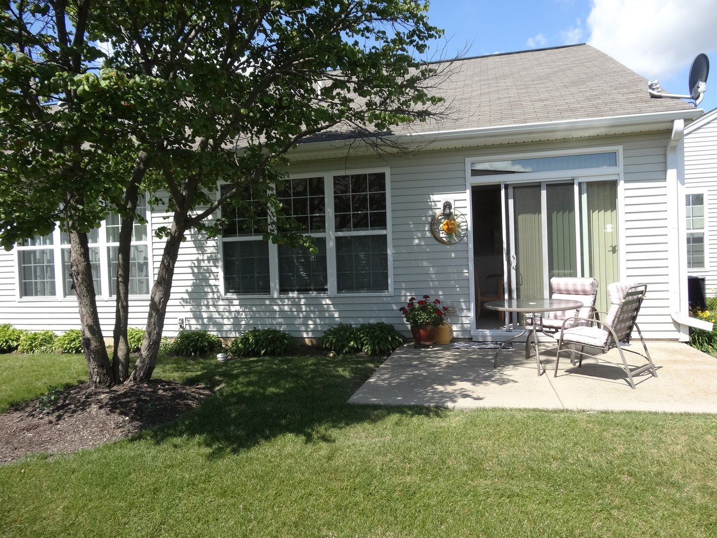 13528 Nealy Road Huntley, IL 60142 - Photo 34 of 39 a view of a house with backyard sitting area and garden