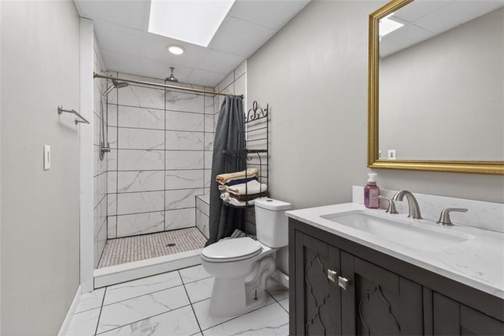 294 Hillcrest Heights Cornelia, GA 30531 - Photo 13 of 66 a bathroom with a sink a toilet and shower