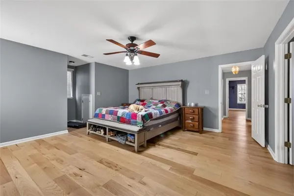a bedroom with a bed and a chandelier