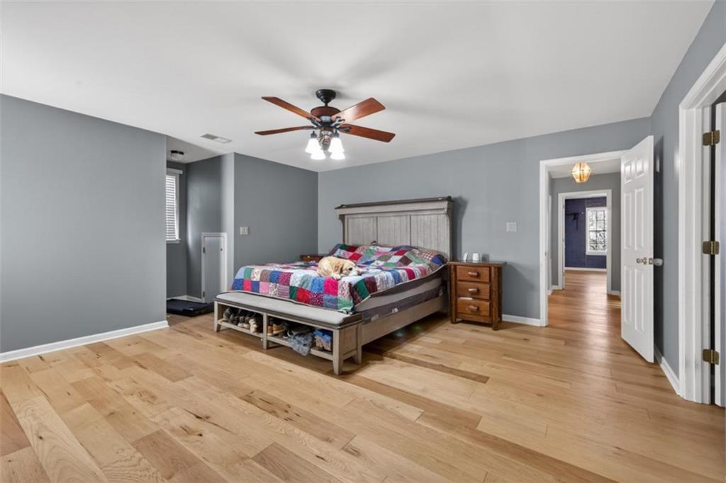294 Hillcrest Heights Cornelia, GA 30531 - Photo 30 of 66 a bedroom with a bed and a chandelier
