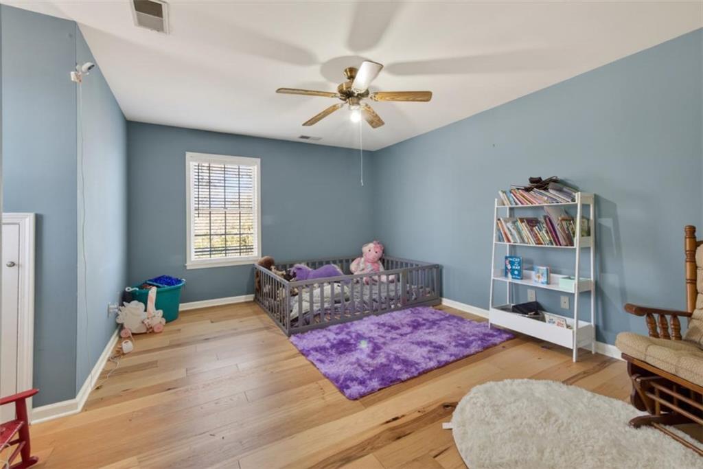 294 Hillcrest Heights Cornelia, GA 30531 - Photo 38 of 66 a bedroom with a bed and a chandelier