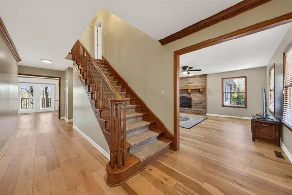 a view of an entryway with wooden floor and stairs
