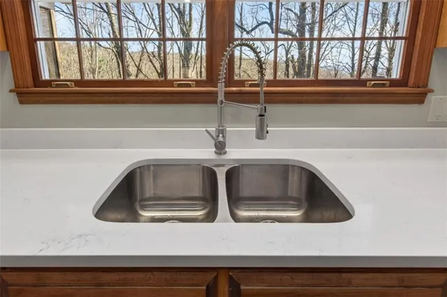 a bathroom with a granite countertop sink vanity mirror and toilet