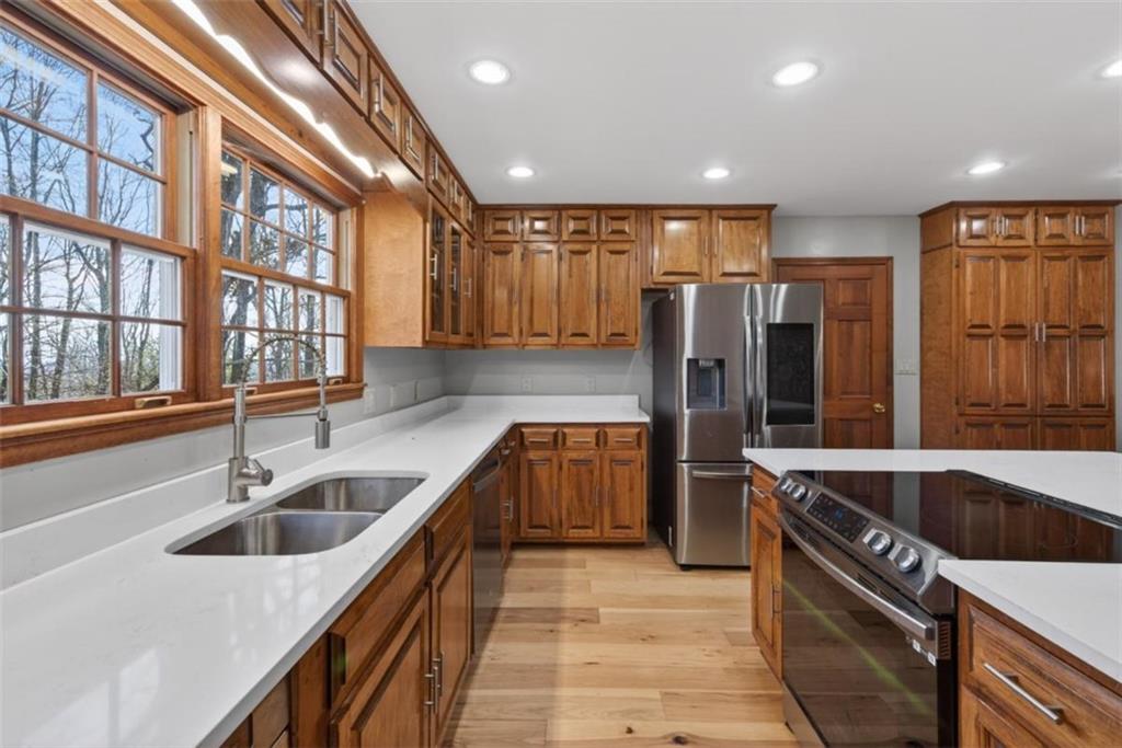 294 Hillcrest Heights Cornelia, GA 30531 - Photo 49 of 66 a kitchen with stainless steel appliances granite countertop a sink and a refrigerator