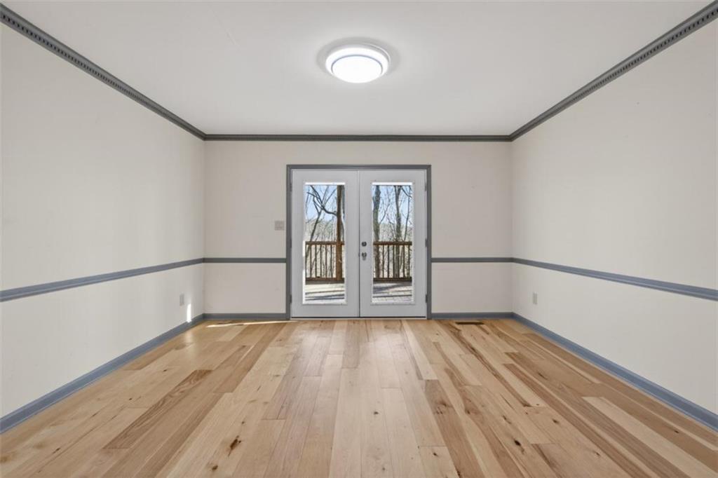 294 Hillcrest Heights Cornelia, GA 30531 - Photo 57 of 66 a view of an empty room with wooden floor and a window