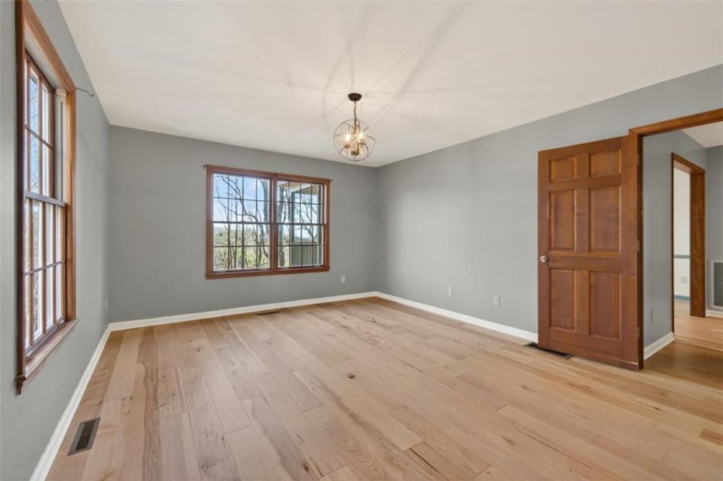 294 Hillcrest Heights Cornelia, GA 30531 - Photo 7 of 66 a view of an empty room with wooden floor and a window