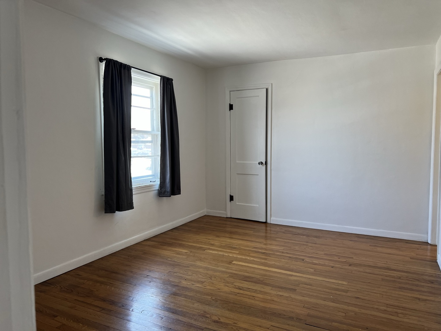 10 East Jefferson Avenue, Unit 2 Naperville, IL 60540 - Photo 12 of 13 an empty room with wooden floor and windows