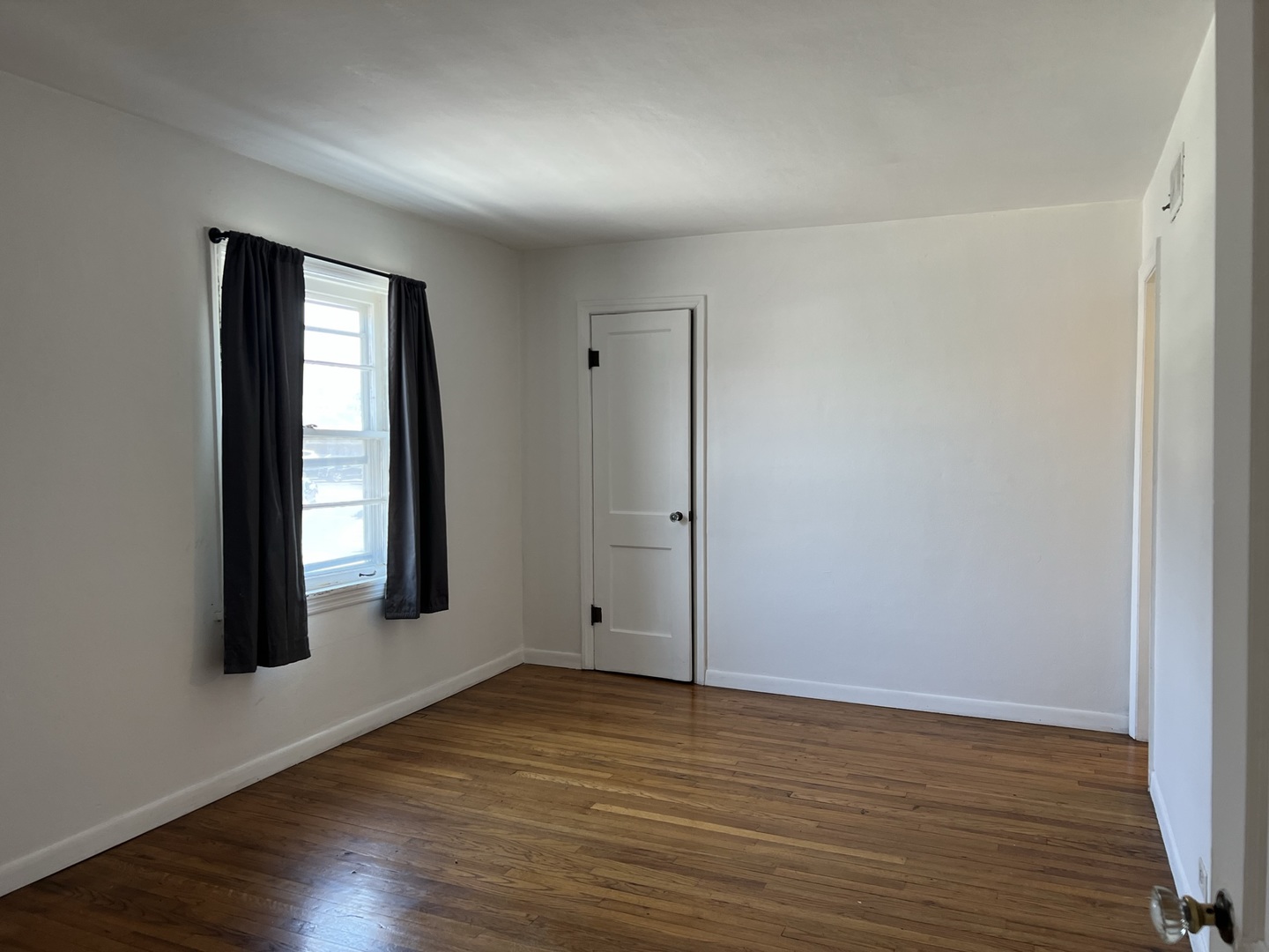 10 East Jefferson Avenue, Unit 2 Naperville, IL 60540 - Photo 5 of 13 a view of an empty room with wooden floor and a window