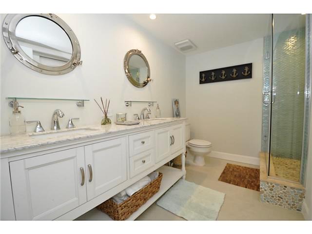 2355 Northeast Ocean Boulevard, Unit 37B Stuart, FL 34996 - Photo 15 of 24 a spacious bathroom with a double vanity sink mirror and toilet