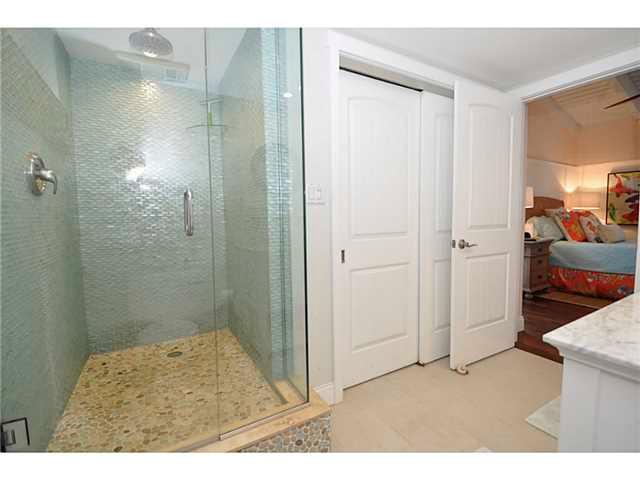 2355 Northeast Ocean Boulevard, Unit 37B Stuart, FL 34996 - Photo 16 of 24 a bathroom with a granite countertop sink a shower and a mirror