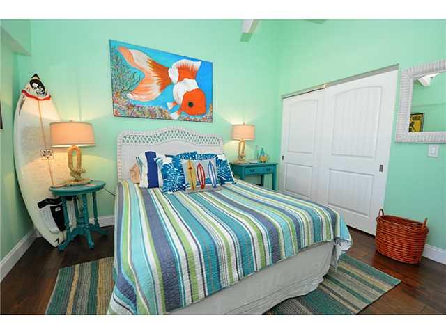 2355 Northeast Ocean Boulevard, Unit 37B Stuart, FL 34996 - Photo 19 of 24 a bedroom with a bed and painting on the wall