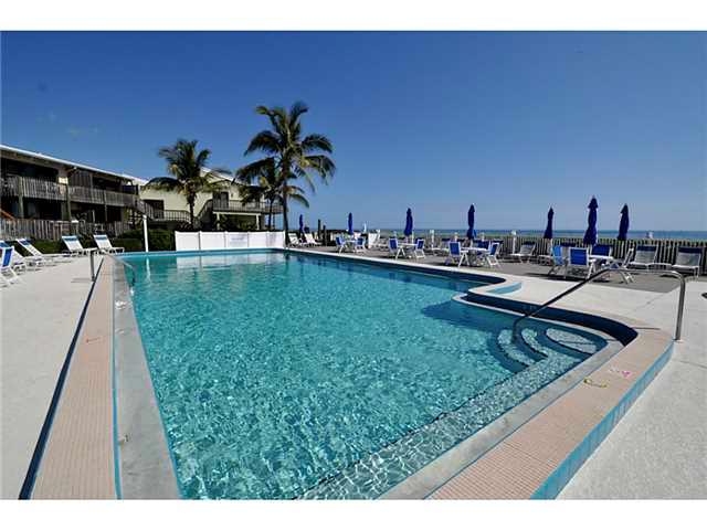 2355 Northeast Ocean Boulevard, Unit 37B Stuart, FL 34996 - Photo 24 of 24 a view of a swimming pool with lounge chairs