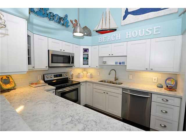 2355 Northeast Ocean Boulevard, Unit 37B Stuart, FL 34996 - Photo 5 of 24 a kitchen with stainless steel appliances granite countertop a sink and cabinets