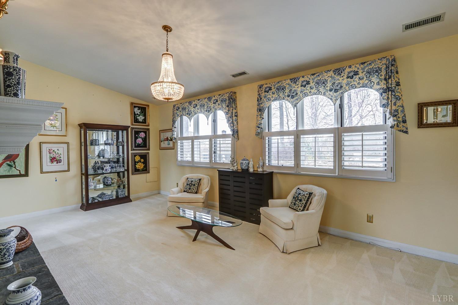 117 Sailview Drive Forest, VA 24551 - Photo 12 of 55 a living room with furniture two window and a chandelier